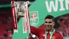 Gelandang Manchester United, Casemiro memegang trofi Carabao Cup 2022/2023 selama perayaan juara usai mengalahkan Newcastle United pada laga final di Stadion Wembley di London, Senin dini hari WIB (27/2/2023). Manchester United atau MU menang 2-0 atas Newcastle United di final Carabao Cup 2022/2023. (AP Photo/Alastair Grant)