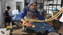 Pekerja menyetrika baju seragam sekolah di rumah ronveksi Fia Busana Sawangan Depok, Jawa Barat, Rabu (08/07/2026). (KLY/ Arie Basuki)