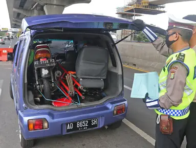 Polisi memeriksa kendaraan di Pos Penyekatan Jalur Mudik, Gerbang Tol Cikarang Barat, Bekasi, Rabu (20/5/2020). Sejak 24 April sampai 19 Mei 2020, Ditlantas Polda Metro Jaya telah memutarbalikkan 20.972 kendaraan mudik Lebaran yang hendak meninggalkan Jabodetabek. (Liputan6.com/Herman Zakharia)