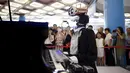 Robot "Teotronico" memperlihatkan kebolehannya memainkan piano dalam acara Konferensi Robot Dunia 2017 di Beijing, 23 Agustus 2017. Selain bisa memainkan piano, robot rancangan Matteo Suzzi ini juga dapat menyanyikan lagu-lagu populer. (WANG Zhao/AFP)