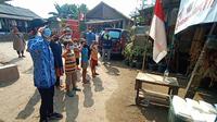 Warga Kampung Pemulung Hormat Bendera Merah Putih Dan Nyanyikan Lagu Indonesia Raya Untuk Dapatkan Nasi Bungkus Gratis. (Selasa, 17/08/2021). (Liputan6.com/Yandhi Deslatama).