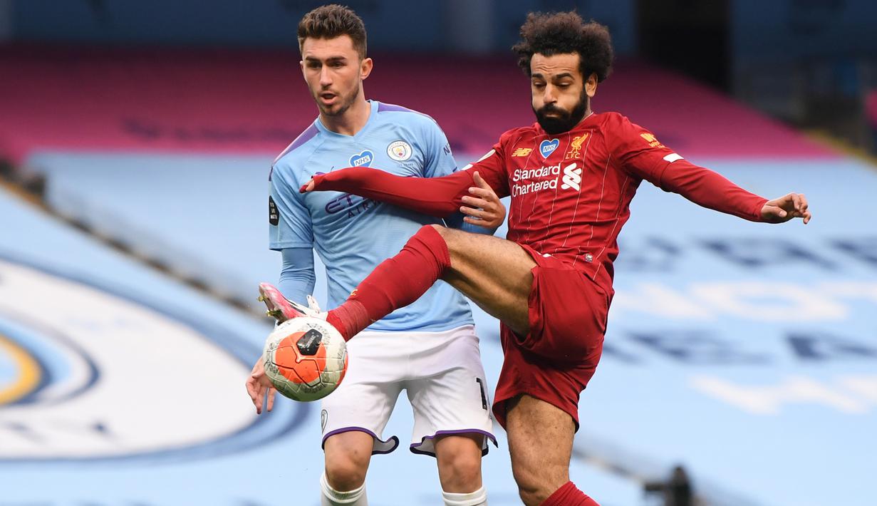 Penyerang Liverpool, Mohamed Salah, berebut bola dengan bek Manchester City, Aymeric Laporte, pada laga lanjutan Premier League pekan ke-32 di Stadion Etihad, Jumat (3/7/2020) dini hari WIB. Manchester City menang 4-0 atas Liverpool. (AFP/Laurence Griffiths/pool)