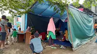 Puluhan pengungsi di tenda darurat di depan kantor Dinsos Sukbar, Selasa (19/01/2021). Selama empat hari di lokasi itu mereka mengaku sulit mengakses kebutuhan dasar; makanan, air, dan MCK. (Liputan6.com/Heri Susanto).