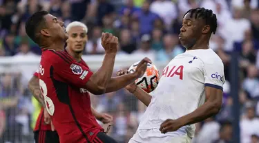 Bek Tottenham Hotspur Destiny Udogie dan gelandang Manchester United (MU) Casemiro bersaing pada laga pekan kedua Premier League 2023/2024  di Tottenham Hotspur Stadium, Sabtu (19/8/2023) malam WIB. (AP Photo/Alberto Pezzali)