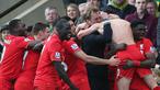 Pemain dan pelatih Liverpool, Jurgen Klopp, merayakan gol kemenangan yang dicetak Adam Lallana ke gawang Norwich pada laga Liga Inggris di Stadion Carrow Road, Inggris, Sabtu (23/1/2016). The Reds berhasil menang 5-4 atas Norwich. (AFP/Alex Morton)