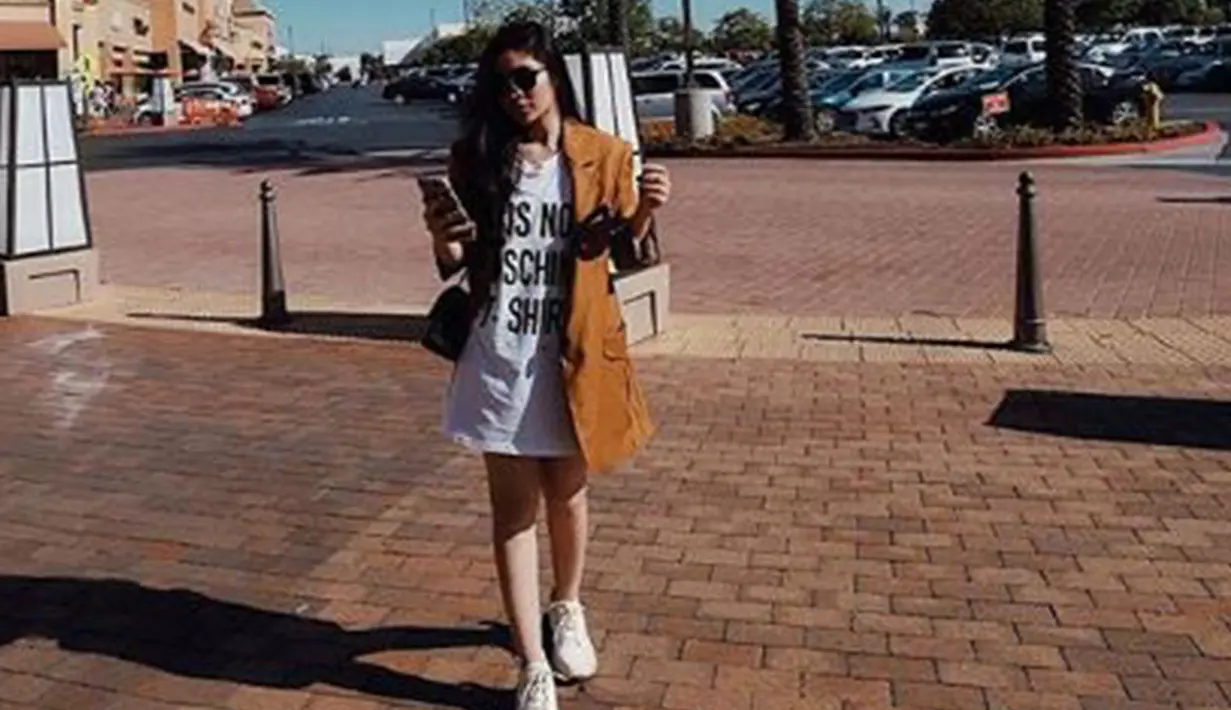 Wanita kelahiran 1996 ini tampil dengan blazer coklat yang dipadukan dengan kaos dan sneakers putih. (Liputan6.com/IG/@febbyrastanty)