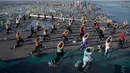 Praktisi yoga menghadiri kelas di Edge Observation Deck, Manhattan, New York, Amerika Serikat, Kamis (17/6/2021). Edge Observation Deck disebut sebagai 'dek langit luar ruang tertinggi di Belahan Barat'. (Ed JONES/AFP)