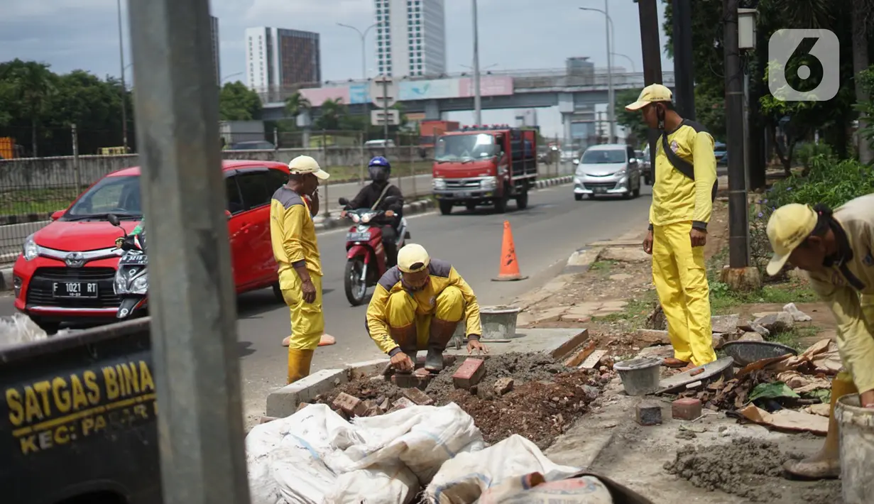 Petugas Bina Marga memerlebar saluran air di Jalan TB Simatupang di kawasan Cilandak, Jakarta, Kamis (22/10/2020). Hal tersebut dilakukan guna memaksimalkan fungsi sistem drainase agar tidak terjadi genangan air saat menghadapi musim hujan. (Liputan6.com/Immanuel Antonius)