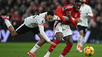 Gelandang Nottingham Forest, Callum Hudson-Odoi (kanan) berebut bola dengan pemain Liverpool, Trent Alexander-Arnold selama pertandingan pekan ke-21 Premier League 2024/2025 di The City Ground, Nottingham, Inggris, pada Selasa 14 Januari 2025 waktu setempat atau Rabu (15/1/2025) dini hari WIB. (Paul ELLIS/AFP)