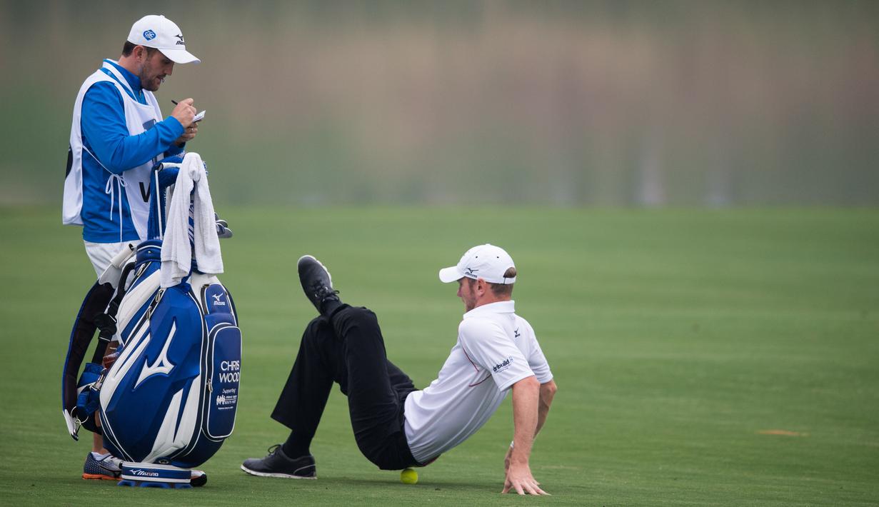 Pegolf Inggris, Chris Wood, melakukan peregangan dalam turnamen golf Shanghai Masters di Lake Malaren Golf Club, Shanghai, Tiongkok, (12/11/2015). (AFP Photo/Johannes Eisele)