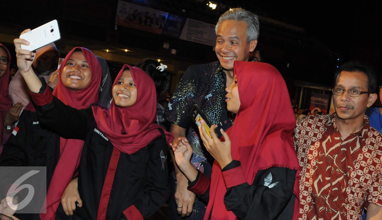 Gubernur Jawa Tengah Ganjar Pranowo berfoto bersama mahasiswa usai acara saat EGTC 2016, Yogjakarta, Kamis (3/11). Ganjar Pranowo menjadi pembicara dalam acara terakhir EGTC 2016 yang digelar di UGM. (Liputan6.com/Helmi Afandi)