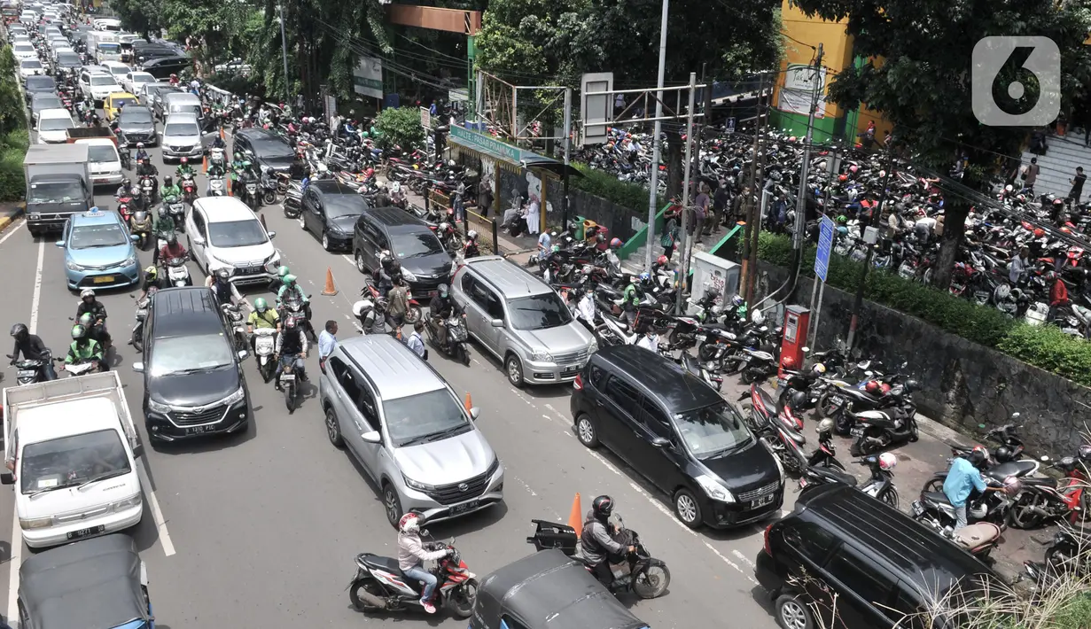 Sejumlah kendaraan mengantre masuk ke Pasar Pramuka, Jakarta, Senin (16/3/2020). Pasar Pramuka diserbu pembeli yang mencari masker guna mengantisipasi virus Corona Covid-19, membuat sebagian badan jalan dimanfaatkan sebagai parkiran sehingga menyebabkan kemacetan panjang. (merdeka.com/Iqbal Nugroho)