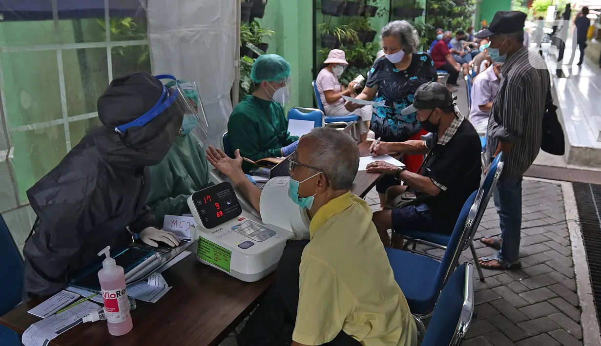 Petugas memeriksa kesehatan warga lansia sebelum mengikuti vaksinasi Covid-19 di Puskesmas Kecamatan Senen, Jakarta Pusat, Selasa (23/2/2021). Vaksinasi untuk Lansia akan dimulai di ibu kota provinsi untuk seluruh provinsi di Indonesia, di prioritaskan di Jawa-Bali. (Liputan6.com/Herman Zakharia)