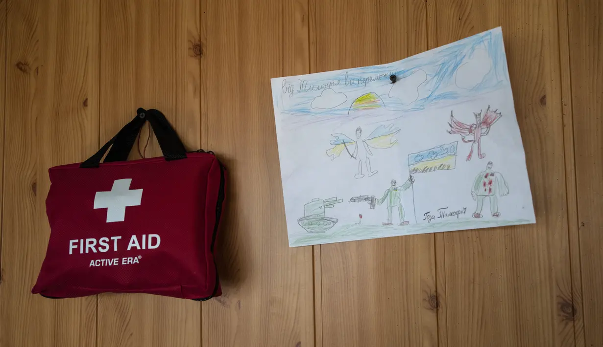 Gambar seorang anak digantung di samping tas P3K di dalam pos pemeriksaan militer, di Lityn, Ukraina, 16 Maret 2022. Invasi Rusia ke Ukraina memasuki hari ke-21. Berbagai upaya negosiasi menuju kompromi telah dilakukan demi menuju perdamaian di antara kedua belah pihak. (AP Photo/Rodrigo Abd)
