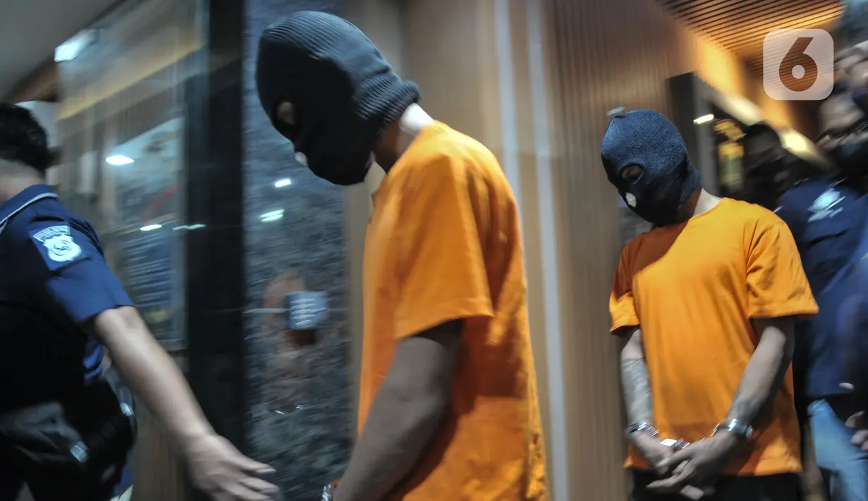 Para tersangka dihadirkan saat rilis kasus mutilasi Bekasi di Jakarta, Minggu (28/11/2021). Polisi mengamankan barang bukti berupa pakaian serta senjata tajam dalam kasus mutilasi dengan korban driver ojol berinisial RS (28). (merdeka.com/Iqbal S Nugroho)