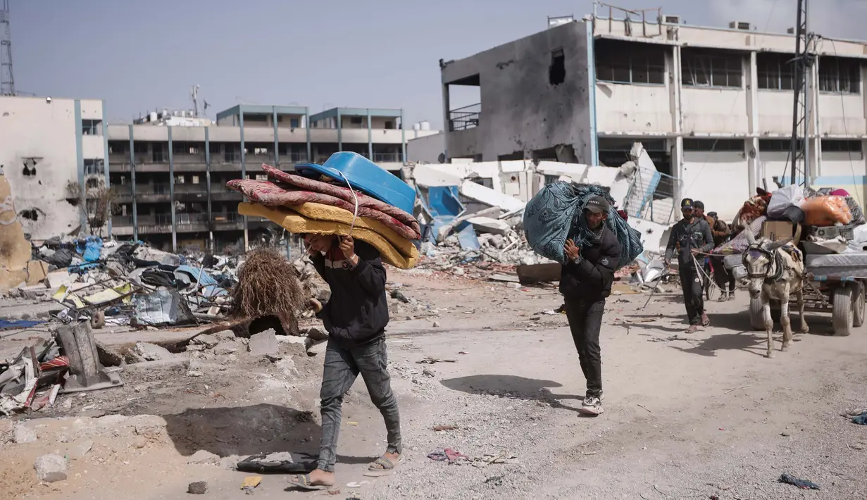 Warga Palestina membawa barang-barang mereka setelah mengunjungi rumah mereka yang hancur akibat serangan Israel di Khan Younis, Jalur Gaza, Rabu, 6 Maret 2024. (AP Photo/Mohammed Dahman)