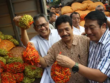 Dirut Bulog, Djarot Kusumayakti (kiri) mengangkat cabai saat operasi pasar di Pasar Induk Kramat Jati, Jakarta, Sabtu (15/8/2015). Operasi pasar ini untuk menekan kenaikan harga cabai yang mencapai Rp 70.000/kg. (Liputan6.com/Gempur M Surya)
