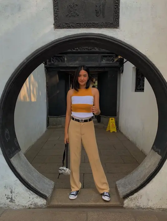 Saat berlibur, wanita kelahiran 15 Oktober 1997 ini sering tampil dengan gaya kasual. Kali ini ia tampil kece dengan atasan motif garis-garis berwarna kuning mustard dan putih. Celana yang dikenakannya pun senada dengan warna bajunya. (Liputan6.com/IG/@nadyaarina)