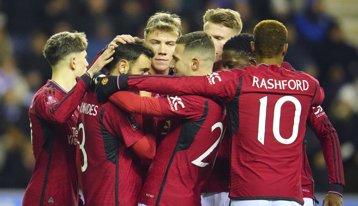 Para pemain Manchester United berselebrasi setelah Bruno Fernandes mencetak gol kedua timnya ke gawang  Wigan Athletic pada laga putaran ketiga FA Cup 2023/2024 di DW Stadium, Selasa (9/1/2024) dini hari WIB. (AP Photo/Jon Super)