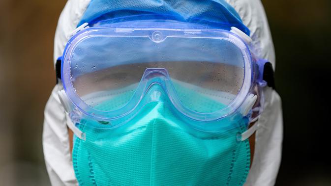 Pekerja medis memakai peralatan pelindung menyusul wabah virus corona di Wuhan, Provinsi Hubei, China, Minggu (26/1/2020). Hingga saat ini lebih dari 600 orang telah meninggal dunia akibat terjangkit virus corona yang mulai mewabah sejak akhir tahun lalu. (Chinatopix via AP)