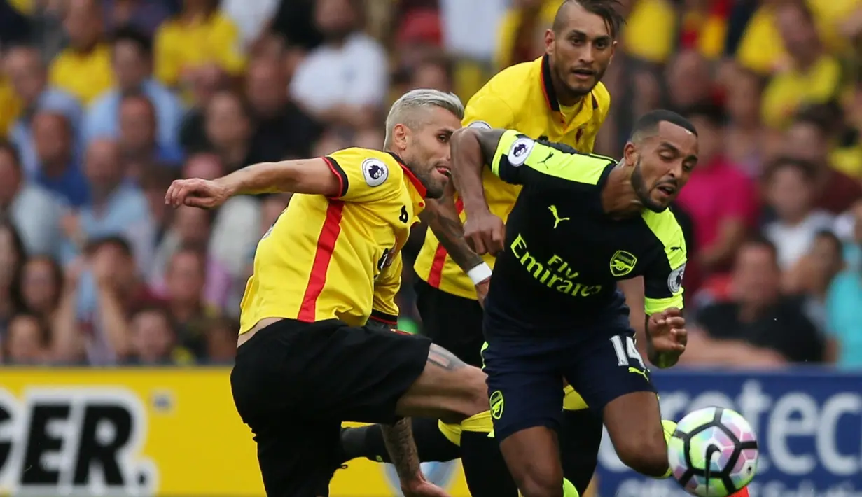 Pemain Arsenal, Theo Walcott, berusaha dihentikan pergerakannya oleh pemain Watford pada laga Premier League 2016-17 di Vicarage Road, Sabtu (27/8/2016). (Action Images via Reuters/Andrew Boyers)
