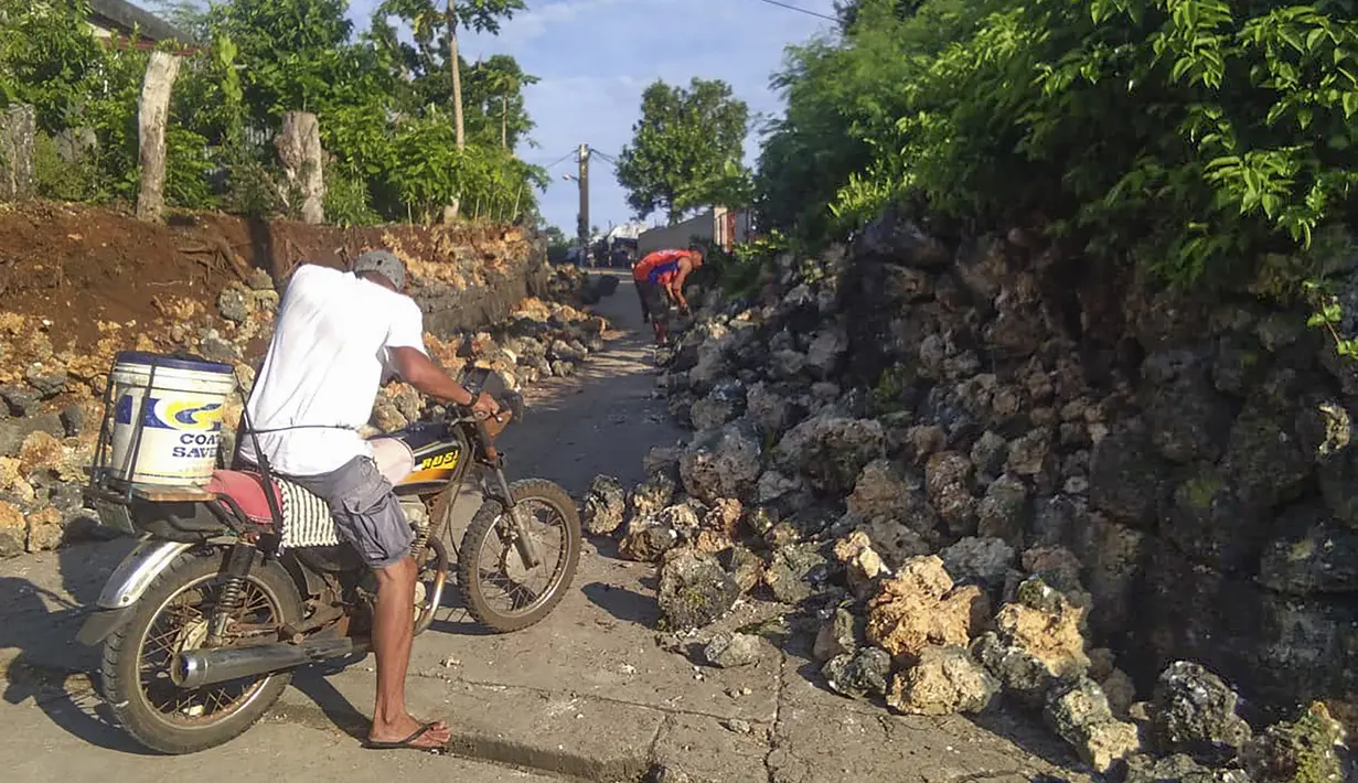 Seorang penduduk melihat kerusakan setelah gempa kembar berkekuatan magnitudo 5,4 dan 5,9 di Itbayat on Pulau Batanes, Filipina (27/7/2019). Banyak orang sedang tidur pulas ketika gempa pertama terjadi pada Sabtu (27/7./2019) pagi. (Agnes Salengua Nico via AP)