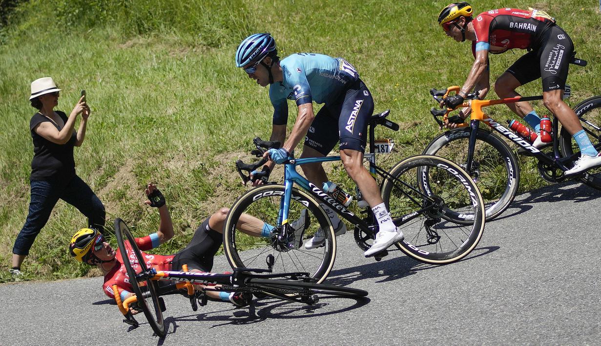 Pembalap Italia, Peio Bilbao jatuh di tikungan saat pembalap Spanyol, Ion Izaguirre Insausti tidak dapat menghindar dan melindas sepedanya pada etape ke-14 balap sepeda Tour de France 2021 yang menempuh jarak 183,7 km, dari Carcassonne menuju Quillan, Prancis, pada 10 Juli 2021. (AP/Christophe Ena)