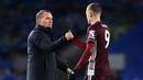 Manajer tim Leicester City, Brendan Rodgers (kiri) menyalami striker Jamie Vardy usai berakhirnya laga lanjutan Liga Inggris 2020/21 melawan Brighton and Hove Albion, Minggu (7/3/2021). Leicester City menang 2-1 atas Brighton. (AFP/Neil Hall/Pool)