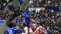 Gelandang Leicester City, Wilfred Ndidi, menyundul bola saat melawan Arsenal pada laga Premier League di Stadion King Power, Minggu (28/4). Leicester City menang 3-0 atas Arsenal. (AFP/Lindsey Parnaby)