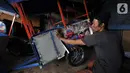 Asep saat hendak menempelkan stiker ondel-ondel pada bodi odong-odong buatannya di Jakarta, Rabu (30/10/2019). Industri rumahan milik Asep Kohar (48) itu sudah 8 tahun memproduksi odong-odong, baik jenis mainan anak maupun kereta mini yang terdiri atas 3 rangkaian. (merdeka.com/Iqbal S. Nugroho)