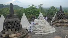 Pekerja menutup stupa di kompleks candi Borobudur, Magelang, Jawa Tengah, Senin (23/11/2020). Penutupan candi Borobudur oleh BKB (Balai Konservasi Borobudur) sebagai langkah antisipasi melindungi batu candi dari abu vulkanik jika Gunung Merapi erupsi. (Photo by Agung Supriyanto/AFP)