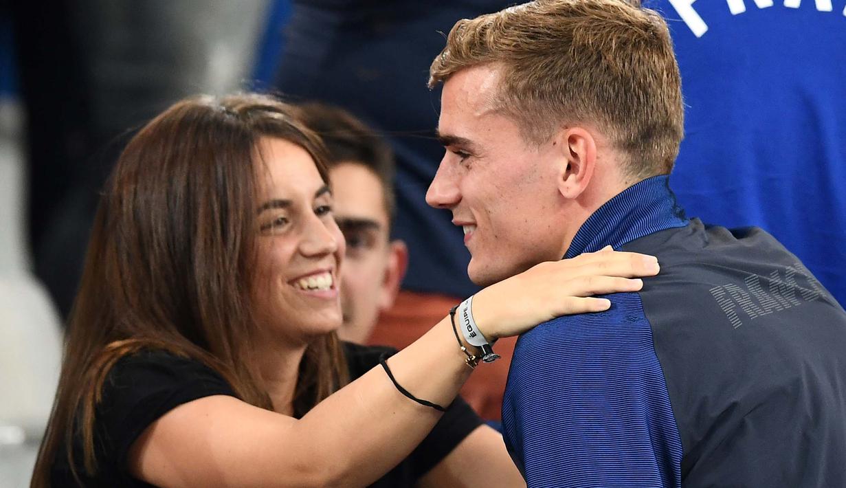 Pemain Prancis, Antoine Griezmann memeluk kekasihnya Erika Choperena setelah timnya menang atas Jerman 2-0 pada piala Eropa 2016 di Stade Velodrome, Marseille (7/7/2016). (AFP/Franck Fife)