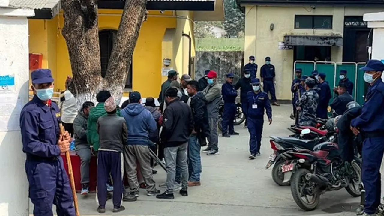 Petugas keamanan berjaga sementara keluarga korban kecelakaan bus menunggu untuk menerima jenazah di sebuah pusat layanan kesehatan di Gajuri, Distrik Dhading, Nepal, pada Senin (23/2/2026).