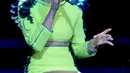 Tidak seperti biasanya, meski tetap dalam balutan 'mini' namun penampilan Miley sedikit lebih tertutup dengan kostum hijau neon. Miley terlihat sangat mendalami nyanyiannya. (Bintang/EPA)