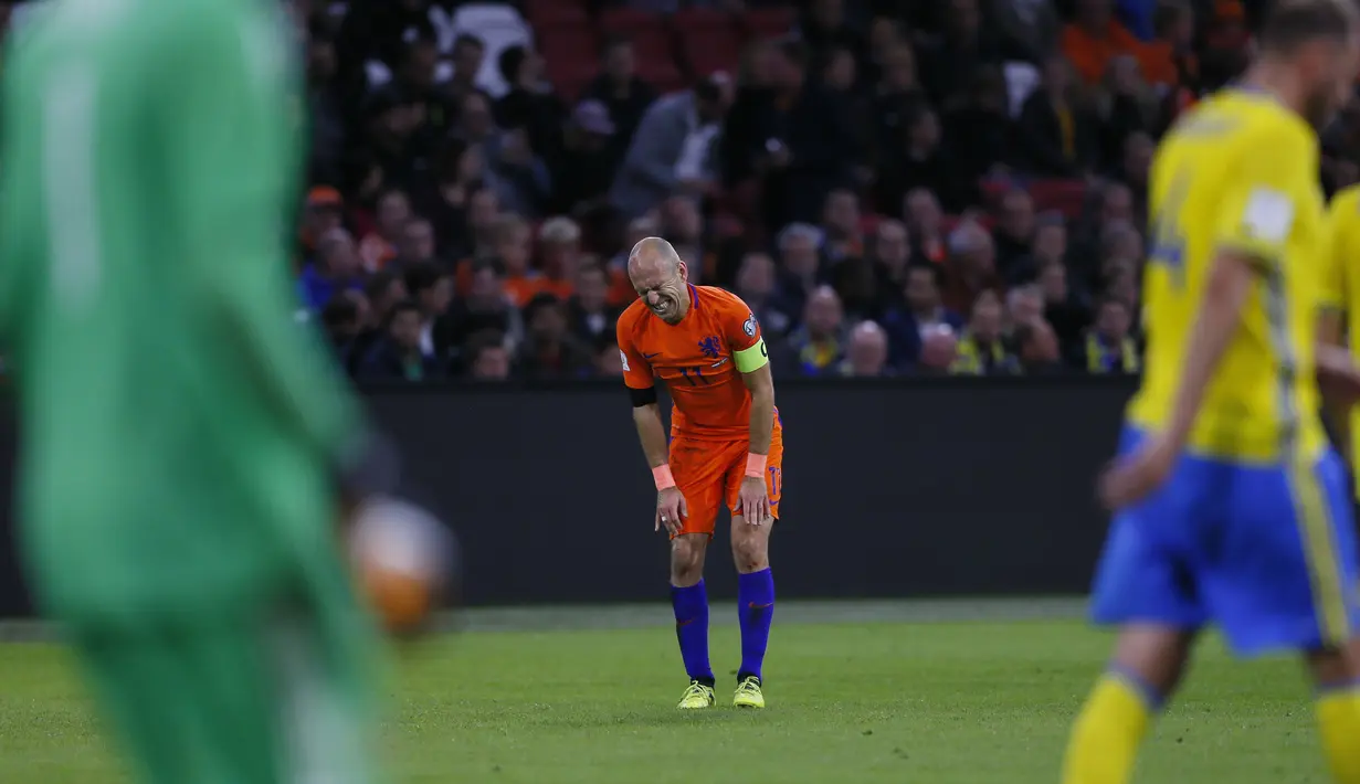 Pemain Belanda, dan Klub Bayern Munchen, Arjen Robben harus mengubur mimpi tampil pada Piala Dunia 2018 usai timnya kalah selisih gol dari Swedia. Robben pun berniat pensiun dari timnas Belanda. (AP/Peter Dejong)