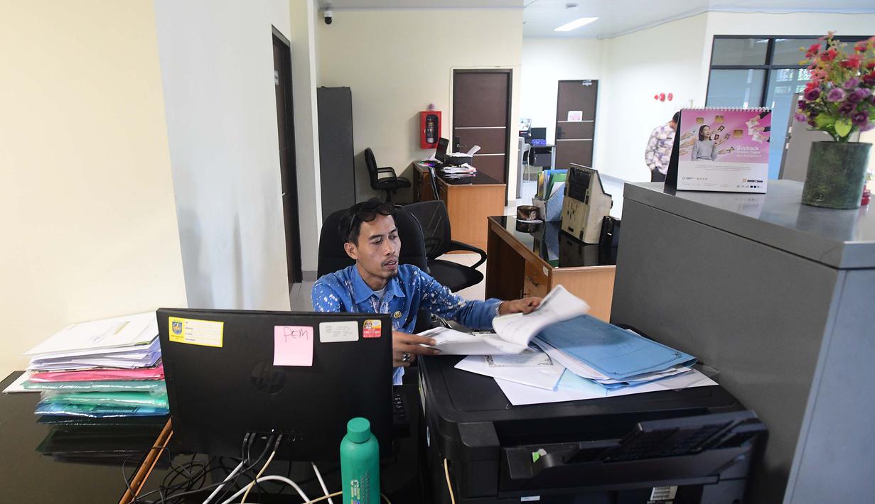 Kebijakan WFH ASN, baik di instansi pusat maupun daerah, dilaksanakan setiap Jumat dan dimulai pada hari ini, 10 April 2026. Tampak dalam foto, pegawai bekerja di depan komputer dengan beberapa meja kursi yang kosong saat penerapan Work From Home (WFH) bagi Aparatur Sipil Negara (ASN) di kantor Kecamatan Limo, Depok, Jawa Barat, Jumat (10/4/2026). (merdeka.com/Arie Basuki)