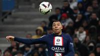 Penyerang Paris Saint-Germain (PSG) Kylian Mbappe menatap bola saat menghadapi Olympique Marseille dalam laga pekan ke-25 Liga Prancis 2022-2023, di Stadion Velodrome pada Senin (27/2/2023) dini hari WIB. Kylian Mbappe menjadi bintang utama dalam kemenangan PSG setelah dirinya mampu mencetak dua gol dan satu assist untuk Lionel Messi.  (CHRISTOPHE SIMON / AFP)