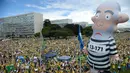 Kubu oposisi membawa balon raksasa dalam unjuk rasa menuntut pengunduran diri Presiden Dilma Rousseff di Esplanada dos Ministerios, Brasil, Minggu (13/3). (Andressa Anholete / AFP)