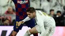 Bek Barcelona, Jordi Alba (kiri) berebut bola dengan gelandang Real Madrid, Federico Valverde pada lanjutan pertandingan La Liga di Santiago Bernabeu, Minggu (2/3/2020).  Real Madrid membungkam Barcelona 2-0 dan merebut puncak klasemen dari Barcelona. (JAVIER SORIANO/AFP)