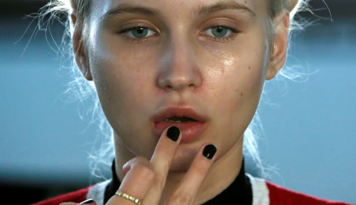 Model cantik mempersiapkan dirinya sebelum tampil di atas panggung dalam memperagakan busana terbaru Adam Selman di ajang New York Fashion Week di Manhattan, New York, Amerika Serikat, (8/9). (REUTERS/Andrew Kelly)
