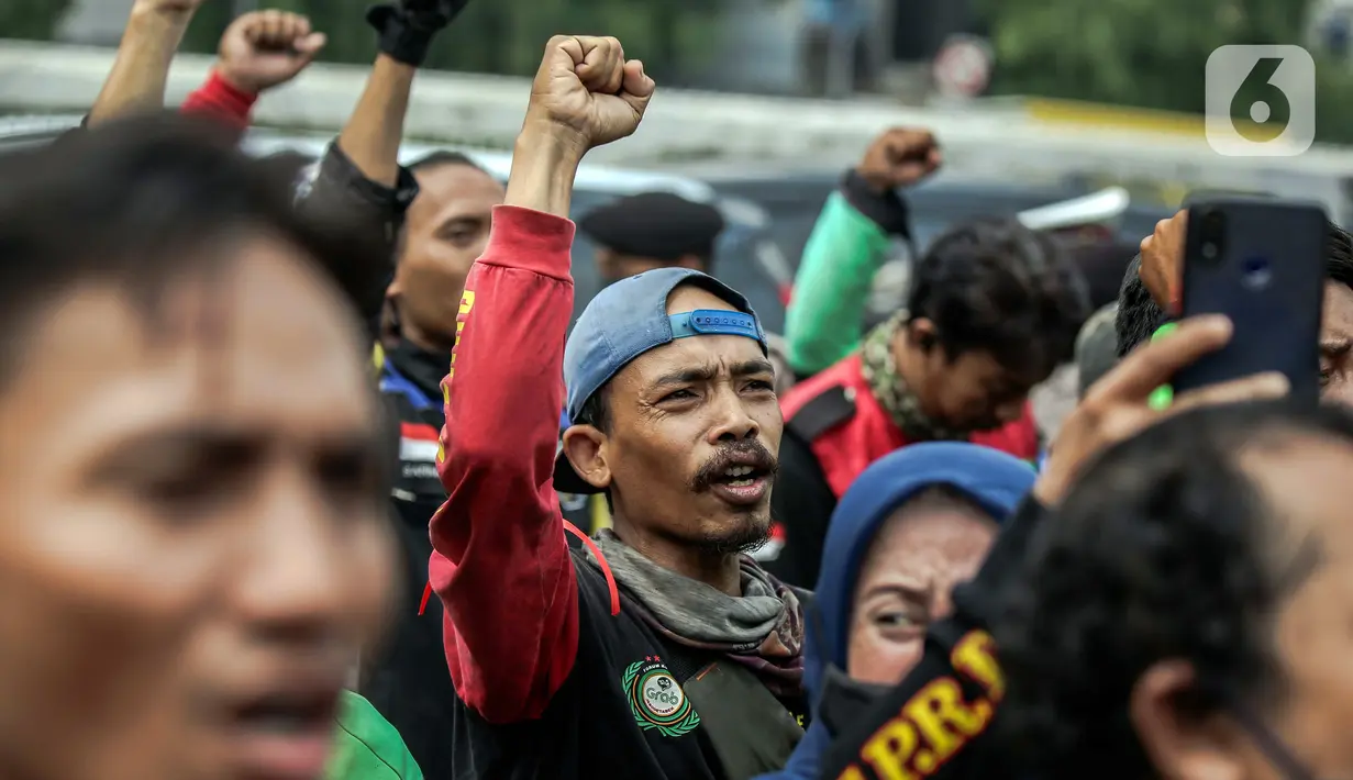 Pengemudi ojek online yang tergabung dalam Koalisi Ojol Nasional menggelar aksi di depan Gedung DPR RI, Jakarta, Senin (29/8/2022). Ratusan pengemudi ojek online tersebut menuntut beberapa hal di antaranya payung hukum dan legalitas profesi ojek online serta revisi potongan komisi pendapatan mitra. (Liputan6.com/Faizal Fanani)