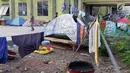 Sejumlah tenda para pencari suaka masih terlihat di halaman gedung bekas Markas Kodim, Kalideres, Jakarta, Selasa (3/9/2019). Pemprov DKI Jakarta memberikan batas waktu hingga 31 Agustus 2019, namun masih banyak pencari suaka memilih bertahan di gedung itu. (Liputan6.com/Helmi Fithriansyah)