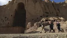 Orang-orang Hazara berjalan di situs patung Buddha raksasa yang dihancurkan oleh Taliban pada 2001 di Provinsi Bamiyan, Afghanistan, 3 Maret 2021. Terletak di jantung pegunungan Hindu Kush, di tebing indah lembah Bamiyan terdapat gua yang berisi kuil, biara, dan lukisan Buddha. (BANGUN KOHSAR/AFP)