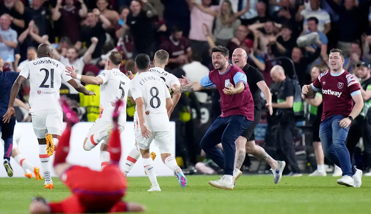 Suporter turun ke lapangan saat merayakan keberhasilan West Ham United menjuarai UEFA Europa Conference League di Stadion Eden Arena, Kamis (8/6/2023). West Ham menang dengan skor 2-1. (AP Photo/Petr David Josek)