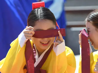 Dua gadis Korea Selatan berbincang saat upacara Coming of Age Day di desa Hanan Namsan di Seoul (21/5). Coming of age day atau Hari Kedewasaan dirayakan pada minggu ketiga bulan Mei. (AFP Photo/Jung Yeon-je)