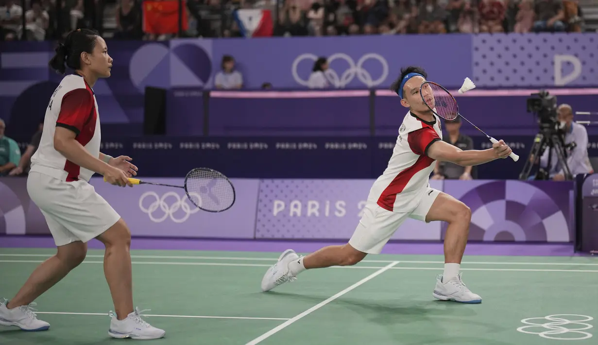 <p>Pemain ganda campuran Indonesia, Rinov Rivaldy (depan) berusaha mengarahkan bola di depan net saat menghadapi wakil China Zheng Siwei/Huang Yaqiong pada laga Grup A nomor ganda campuran bulu tangkis Olimpiade Paris 2024 di Porte de la Chapelle Arena, Prancis, Minggu (28/7/2024). Rinov/Pitha kalah 0-2 (10-21, 3-21). (AP Photo/Dita Alangkara)</p>