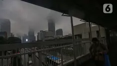 Warga melintas di salah satu Jembatan Penyeberangan Orang (JPO) berlatar suasana gedung bertingkat yang diselimuti kabut di sekitar jalan Jenderal Gatot Subroto, Jakarta, Sabtu (6/7/2024). (Liputan6.com/Angga Yuniar)