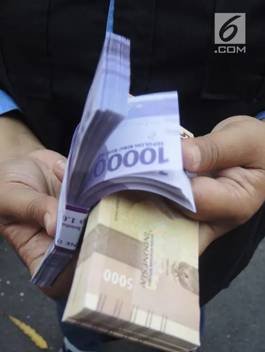 Petugas bank menyiapkan uang pecahan untuk layanan penukaran uang baru di GOR Tri Lomba Juang, Kota Semarang,  Senin (20/5/2019). Pelaksanaan layanan penukaran guna memenuhi kebutuhan uang pecahan untuk lebaran ini berlangsung secara bergantian mulai 20-23 Mei 2019. (Liputan6.com/Gholib)