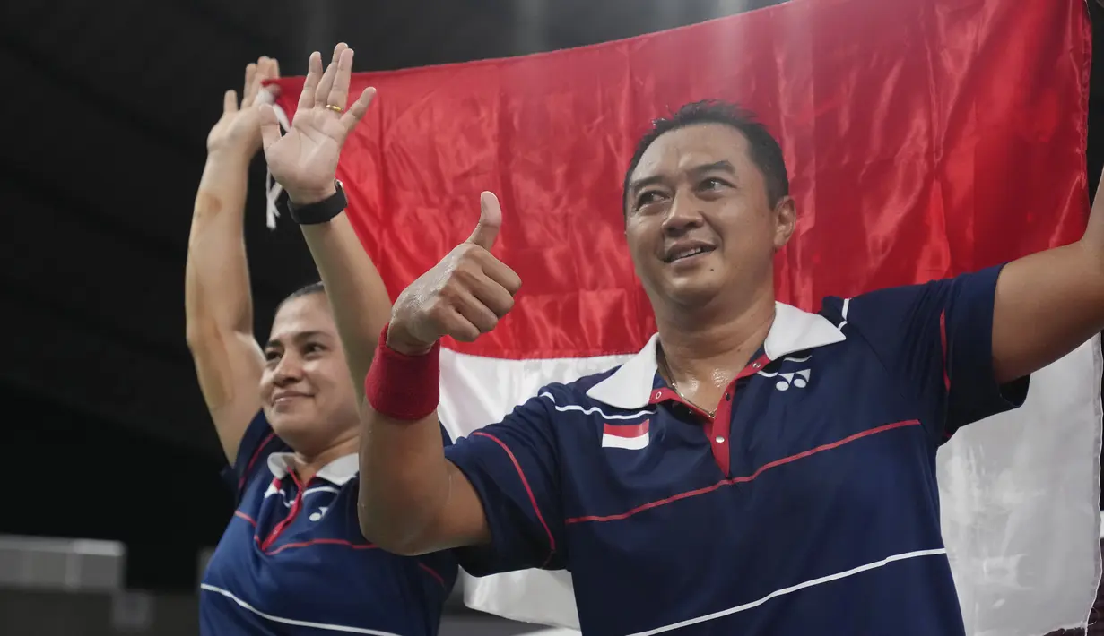 Hary Susanto dan Leani Ratri Oktila berselebrasi usai menang melawan pasangan Prancis Lucas Mazur dan Faustine Noel pada pertandingan ganda campuran cabang badminton nomor SL3-SU5 Paralimpiade Tokyo 2020, Minggu (5/9/2021). Hary/Leani meraih medali emas usai menang 23-21 dan 21-17 (AP/Kiichiro Sato)