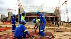 South African labourers work in front of Nelspruit's new football stadium on January 19, 2009 that will be used as one of the 10 stadiums across South Africa for the 2010 World Cup. AFP PHOTO/ALEXANDER JOE 